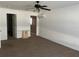 Bedroom with carpet, white walls, ceiling fan and attached walk-in closet at 423 Chimney Rock Dr, Ruskin, FL 33570