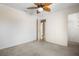 Carpeted bedroom featuring a ceiling fan and an ensuite bathroom with tile flooring at 423 Chimney Rock Dr, Ruskin, FL 33570