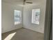 Bare bedroom with carpet flooring and two windows allowing natural light to enter the room at 423 Chimney Rock Dr, Ruskin, FL 33570