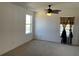 Bedroom featuring a ceiling fan, carpet flooring, and two windows; one dressed with gold drapes at 423 Chimney Rock Dr, Ruskin, FL 33570