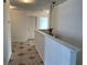 Hallway featuring geometric tile flooring and chandelier lighting at 423 Chimney Rock Dr, Ruskin, FL 33570