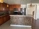 Kitchen island featuring a mosaic tile finish and granite countertop, complimented by stainless steel appliances at 423 Chimney Rock Dr, Ruskin, FL 33570