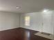 Bright living room with hardwood floors, white walls, and a window letting in natural light at 423 Chimney Rock Dr, Ruskin, FL 33570