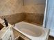 Relaxing bathroom with soaking tub and tile surround at 809 Daphne Dr, Brandon, FL 33510