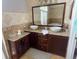 Double vanity bathroom with granite countertops and dark wood cabinets at 809 Daphne Dr, Brandon, FL 33510