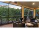 Relaxing screened patio with seating area, fire pit, and view of lush landscaping at 933 Riverscape St, Bradenton, FL 34208