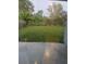 View of the backyard overlooking a lush lawn and mature trees and shrubbery at 13034 Avalon Crest Ct, Riverview, FL 33579