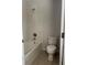 Bathroom with shower-tub combo, toilet, and neutral tile at 13034 Avalon Crest Ct, Riverview, FL 33579