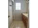 Bathroom with a double sink vanity and window providing natural light at 13034 Avalon Crest Ct, Riverview, FL 33579