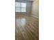 Bedroom featuring laminate flooring and a window with blinds at 13034 Avalon Crest Ct, Riverview, FL 33579