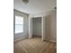 Bright bedroom featuring neutral paint, carpet flooring, and a closet with bi-fold doors at 13034 Avalon Crest Ct, Riverview, FL 33579