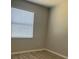 Neutral bedroom featuring a large window with blinds and wood floors at 13034 Avalon Crest Ct, Riverview, FL 33579