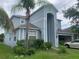 Two-story home featuring a stucco exterior, attached garage, and mature landscaping at 13034 Avalon Crest Ct, Riverview, FL 33579