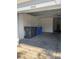 A spacious two-car garage with a number on top and several bins at 13034 Avalon Crest Ct, Riverview, FL 33579