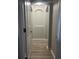 Hallway featuring laminate flooring and an arched opening at the end at 13034 Avalon Crest Ct, Riverview, FL 33579