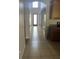 Bright hallway features tile flooring, archways, and a view of the front door at 13034 Avalon Crest Ct, Riverview, FL 33579