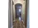 Hallway featuring tile flooring and an arched opening leading to another room at 13034 Avalon Crest Ct, Riverview, FL 33579