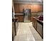 View of a kitchen with stainless steel appliances, granite counters, and tiled flooring at 13034 Avalon Crest Ct, Riverview, FL 33579