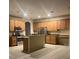 Spacious kitchen featuring stainless steel appliances, wooden cabinetry, and tiled flooring at 13034 Avalon Crest Ct, Riverview, FL 33579