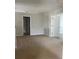 Neutral living room with carpet, bright light, and access to other rooms at 13034 Avalon Crest Ct, Riverview, FL 33579