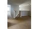 Open loft area with neutral carpet, staircase, and hanging light fixture at 13034 Avalon Crest Ct, Riverview, FL 33579