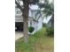 The exterior side of the home features a light-blue stucco finish and a lush green yard at 13034 Avalon Crest Ct, Riverview, FL 33579