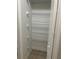A closet with built-in shelving and tiled floor, offering ample storage at 13034 Avalon Crest Ct, Riverview, FL 33579