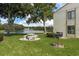 Quaint backyard with picnic table, grill, and lake view at 3133 Lake Pine Way # D1, Tarpon Springs, FL 34688