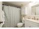 Clean bathroom with shower/tub combo, vanity, and linen storage at 3133 Lake Pine Way # D1, Tarpon Springs, FL 34688