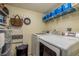 Practical laundry room with washer, dryer, and shelving at 3133 Lake Pine Way # D1, Tarpon Springs, FL 34688