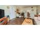 Living room with hardwood floors, showing kitchen and entryway at 3133 Lake Pine Way # D1, Tarpon Springs, FL 34688