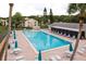 Community pool area with ample seating and lounge chairs at 3133 Lake Pine Way # D1, Tarpon Springs, FL 34688