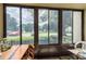 Bright sunroom with view of parking lot and trees at 3133 Lake Pine Way # D1, Tarpon Springs, FL 34688