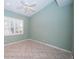 A bright bedroom with neutral paint, tile floor and window shutters allowing for natural light at 4350 Live Oak Blvd, Palm Harbor, FL 34685