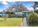 Ranch home with teal door and well-manicured lawn at 509 Langford Cir, Plant City, FL 33563