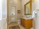 Powder room with ornate mirror and custom cabinetry at 7877 Bayou Club Blvd, Seminole, FL 33777