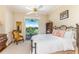 Bedroom with a king-size bed and access to a private balcony overlooking a golf course at 7877 Bayou Club Blvd, Seminole, FL 33777