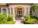 Elegant home entrance with double doors and landscaping at 7877 Bayou Club Blvd, Seminole, FL 33777