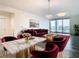Elegant living room with marble dining table and red velvet furniture at 920 N Osceola Ave # 703, Clearwater, FL 33755