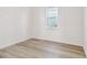 Simple bedroom with wood-look flooring and a window at 13728 Sunlight Meadow Dr, Riverview, FL 33578