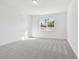 Bright bedroom with neutral walls and plush carpeting at 13728 Sunlight Meadow Dr, Riverview, FL 33578