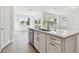 Kitchen island with quartz countertop, sink, and dishwasher at 13728 Sunlight Meadow Dr, Riverview, FL 33578