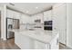 Modern kitchen featuring white cabinets, stainless steel appliances, and a large island at 13728 Sunlight Meadow Dr, Riverview, FL 33578