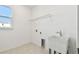 Laundry room with utility sink and shelving at 13728 Sunlight Meadow Dr, Riverview, FL 33578