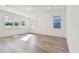 Open living room with hardwood floors and neutral color palette at 13728 Sunlight Meadow Dr, Riverview, FL 33578