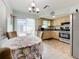 Open concept kitchen and dining area with light flooring at 7809 39Th N Ave, St Petersburg, FL 33709