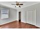 Well-lit bedroom with hardwood floors, a closet, a ceiling fan and a window at 11335 Flora Springs Dr, Riverview, FL 33579