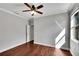 Bright bedroom with a ceiling fan, wood floors, and natural light from a window at 11335 Flora Springs Dr, Riverview, FL 33579