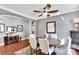 Dining room with a ceiling fan, light gray walls, and round wood table at 11335 Flora Springs Dr, Riverview, FL 33579