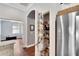 Walk-in pantry with adjustable shelving, and a modern stainless steel refrigerator at 11335 Flora Springs Dr, Riverview, FL 33579